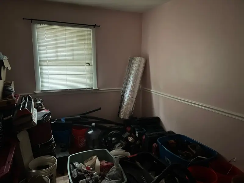 Spare room packed with bins, buckets and tools, Shirley, NY